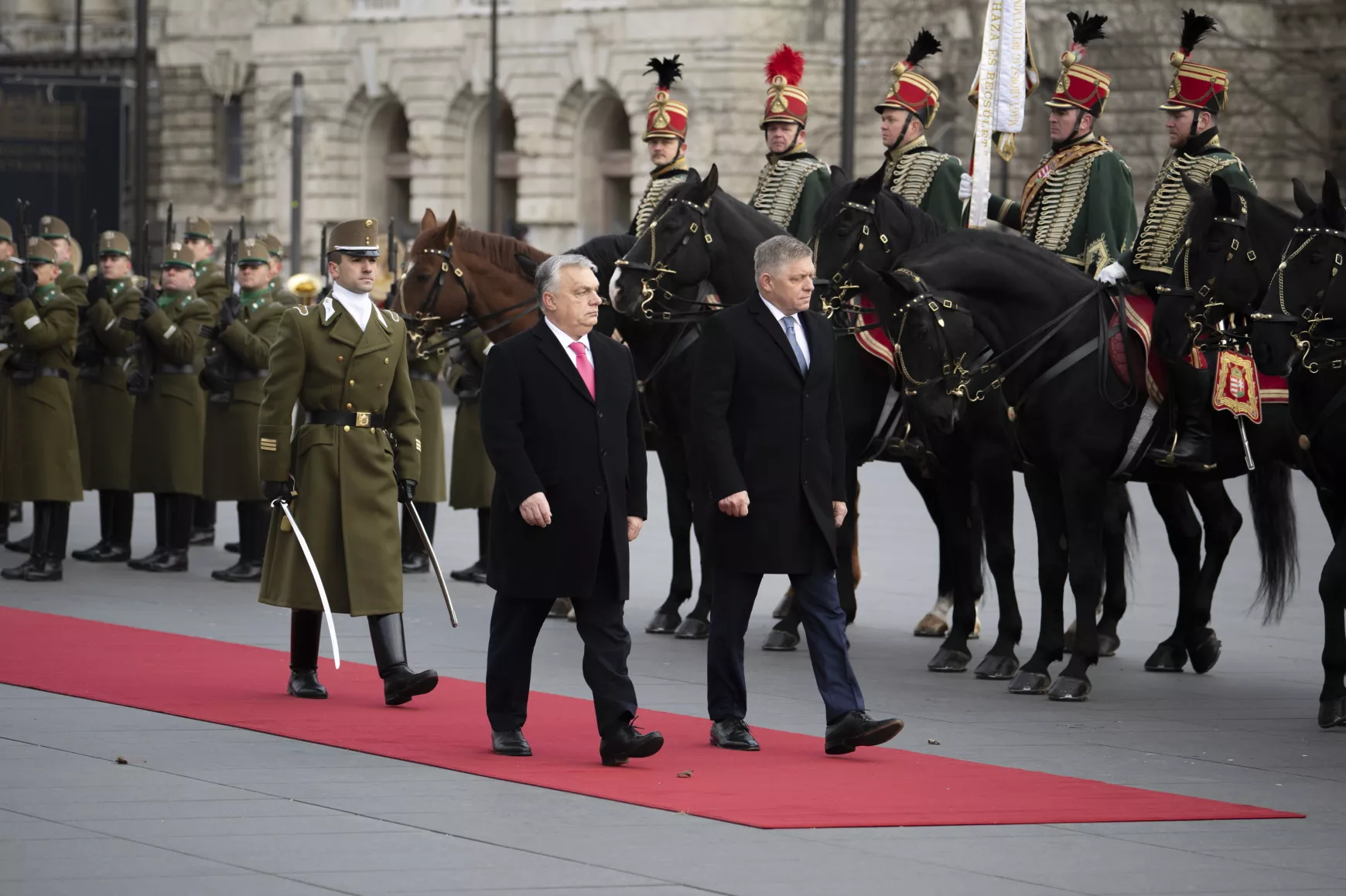 Orbán Viktor  magyar miniszterelnök (b) katonai tiszteletadással fogadja Robert Fico szlovák kormányfőt (j) az Országház előtt, a Kossuth Lajos téren